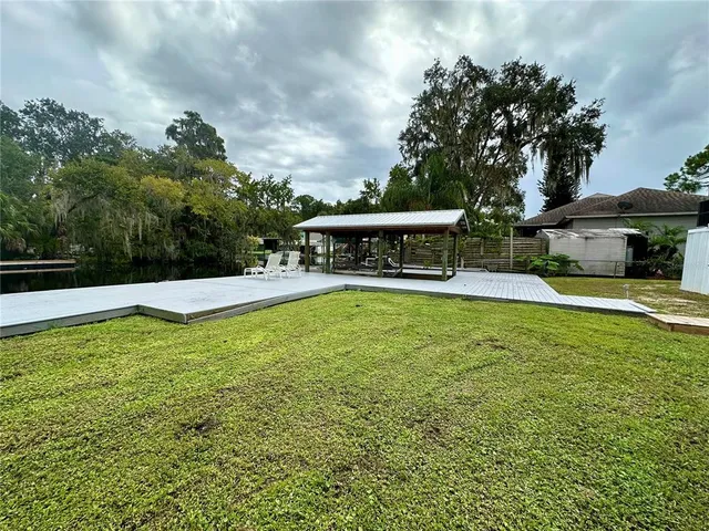 a view of a house with swimming pool and sitting area