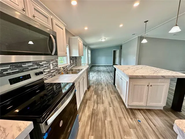 a kitchen with a sink stove and cabinets