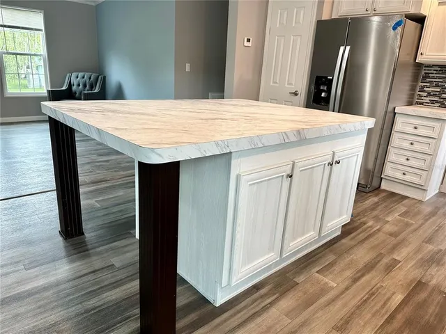 a kitchen with stainless steel appliances granite countertop a sink stove and cabinets