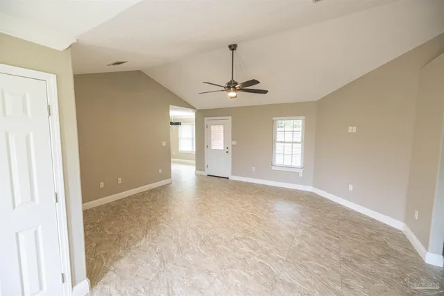 a view of an empty room with a window