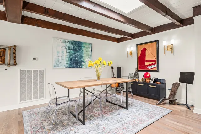 a large kitchen with kitchen island a sink table and chairs
