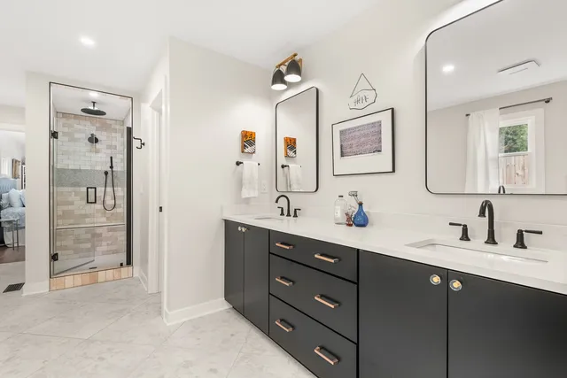 a bathroom with a granite countertop sink a toilet and a mirror