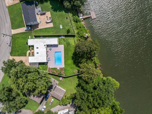 an aerial view of a house with outdoor space and lake view