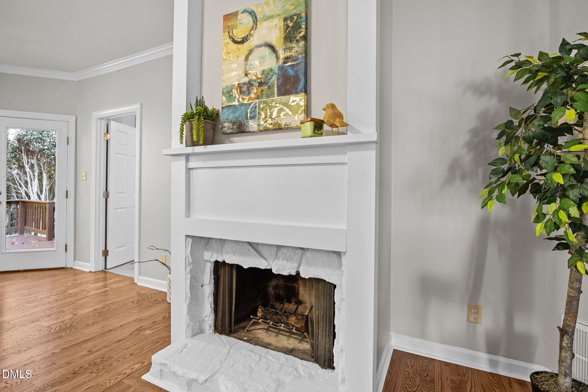 5935 Sentinel Drive Raleigh, NC 27609 - Photo 19 of 53 a living room with a fireplace and a potted plant