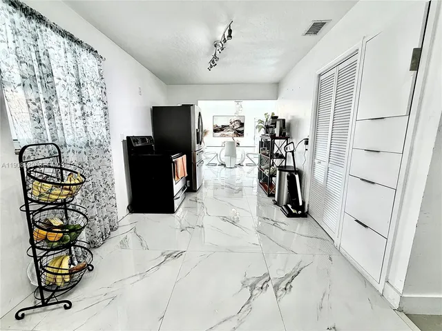 a view of a entryway with furniture and chandelier