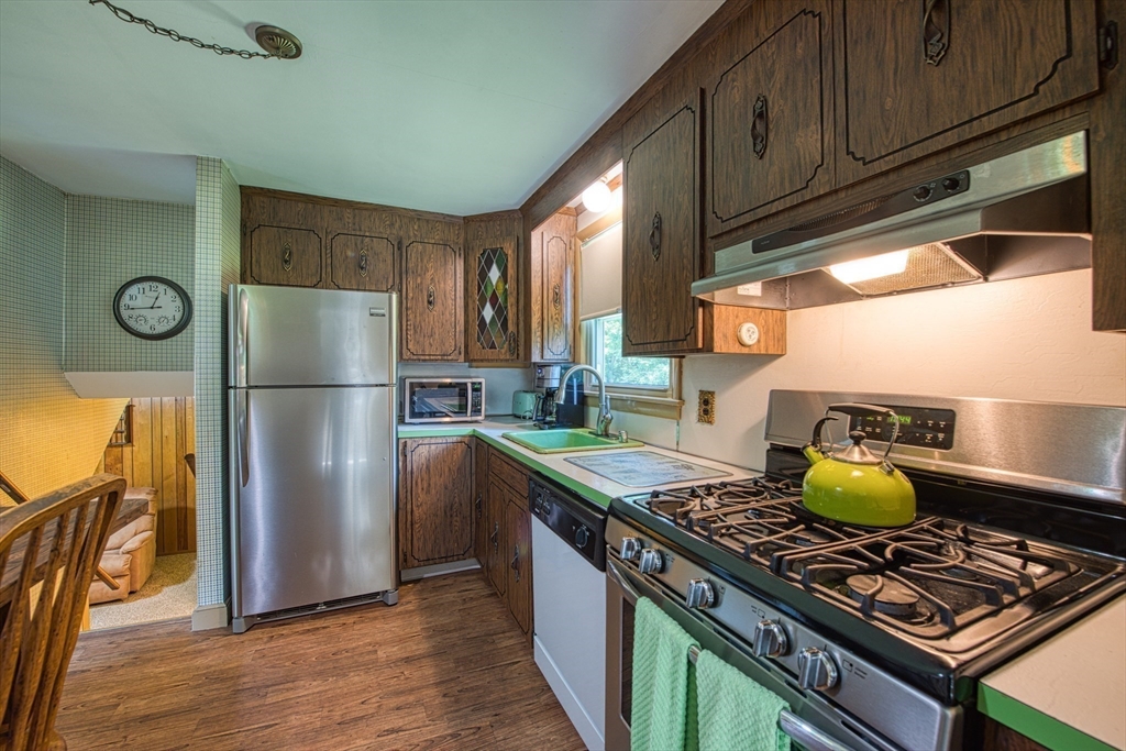 150 Pond Street Sharon, MA 02067 - Photo 11 of 26 a kitchen with stainless steel appliances granite countertop a stove a refrigerator and a refrigerator