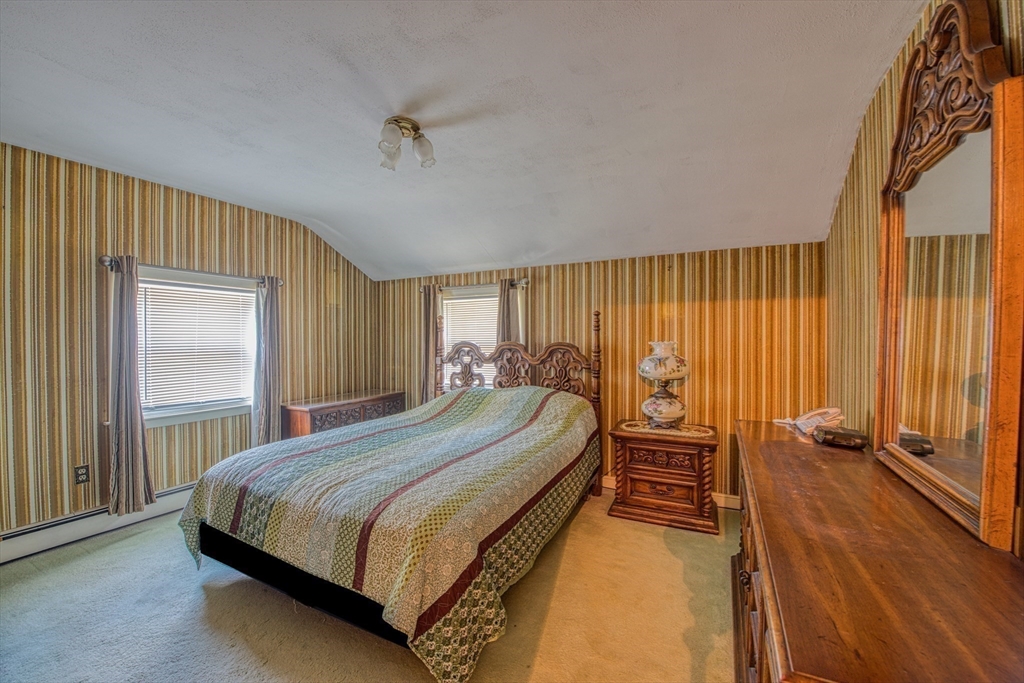 150 Pond Street Sharon, MA 02067 - Photo 14 of 26 a bed sitting in a spacious bedroom next to a window