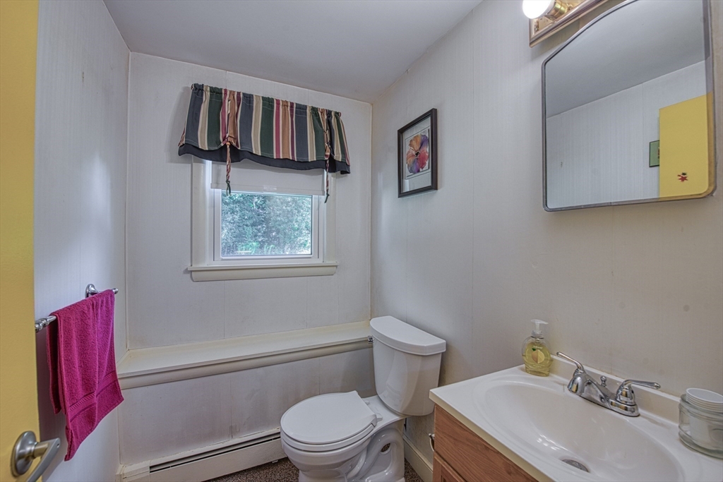 150 Pond Street Sharon, MA 02067 - Photo 18 of 26 a bathroom with a toilet sink and mirror