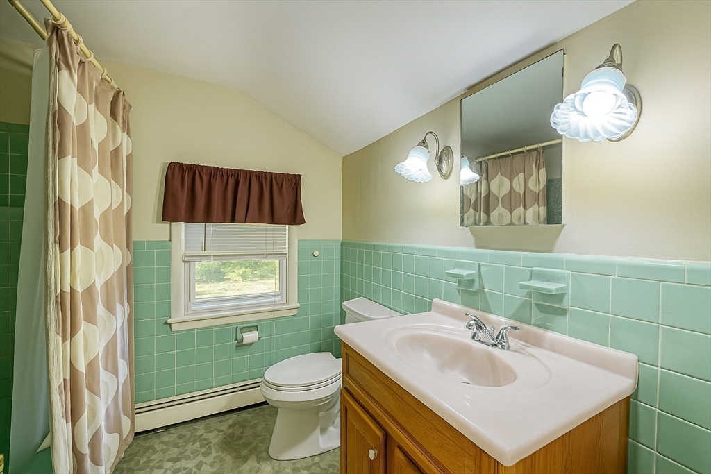 150 Pond Street Sharon, MA 02067 - Photo 21 of 26 a bathroom with a sink a toilet and mirror