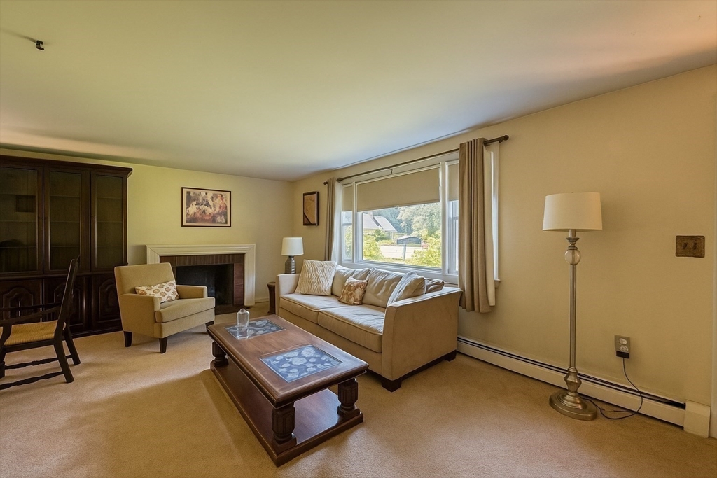 150 Pond Street Sharon, MA 02067 - Photo 5 of 26 a living room with furniture a fireplace and a window