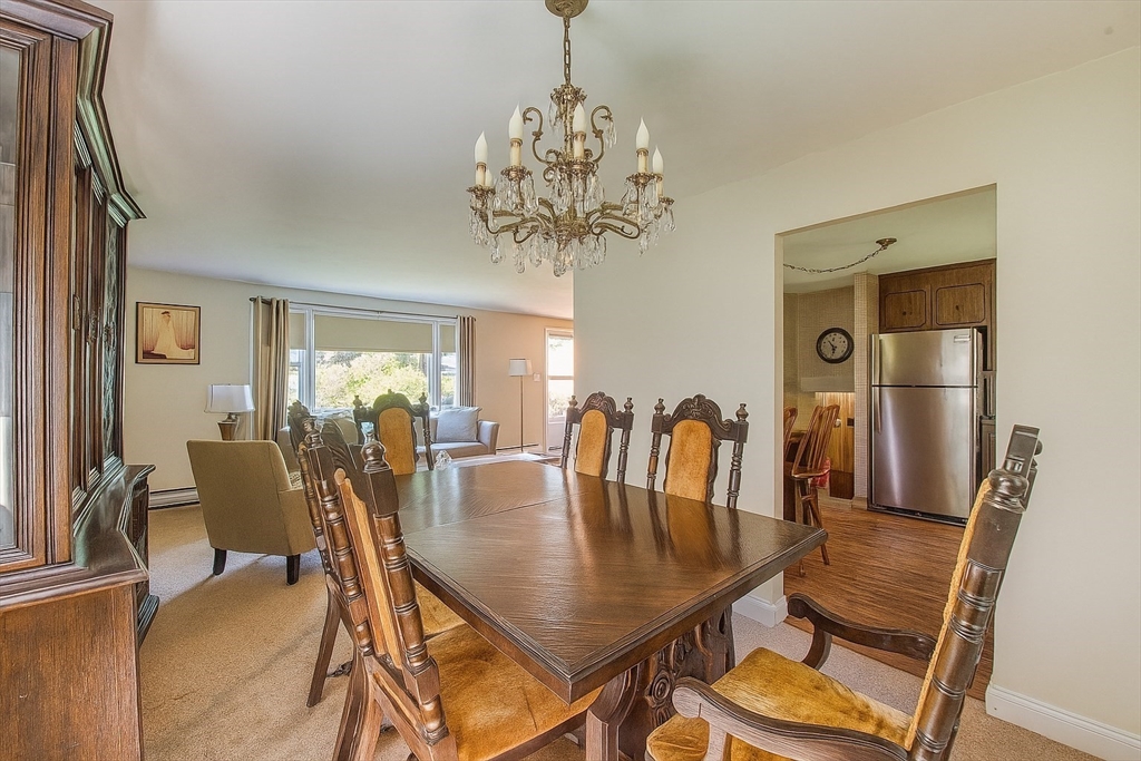 150 Pond Street Sharon, MA 02067 - Photo 6 of 26 a view of a dining room with furniture and chandelier