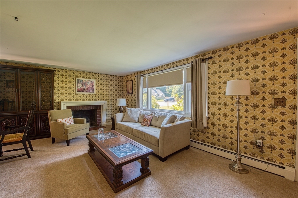 150 Pond Street Sharon, MA 02067 - Photo 8 of 26 a living room with furniture and a fireplace