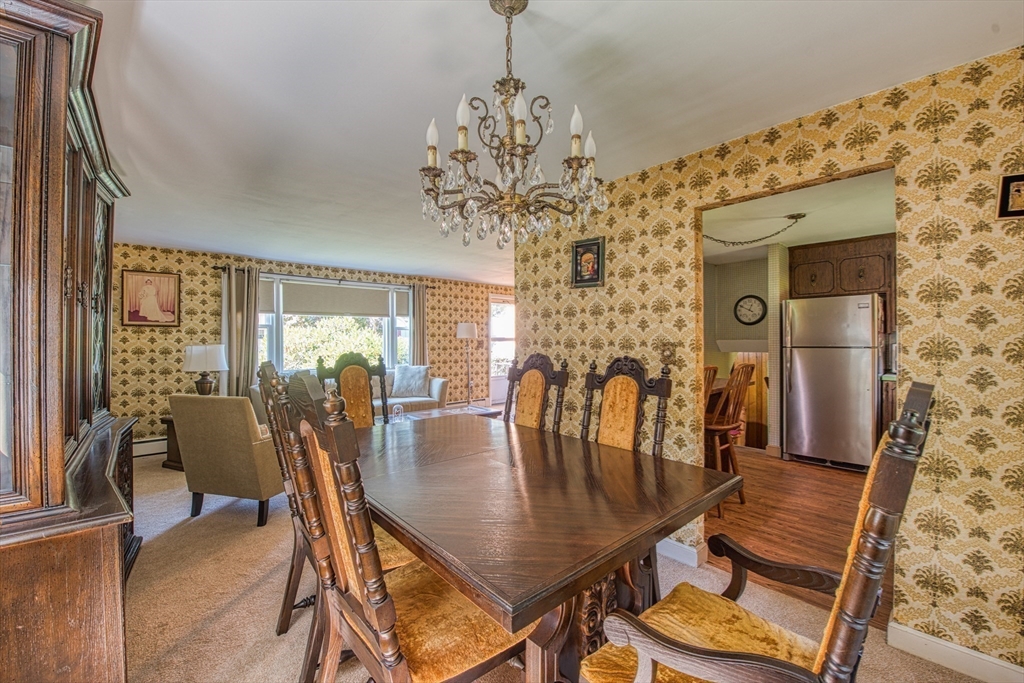 150 Pond Street Sharon, MA 02067 - Photo 9 of 26 a dining room with furniture a chandelier and wooden floor