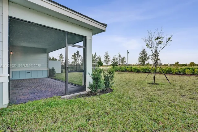 an aerial view of house with yard and lake view