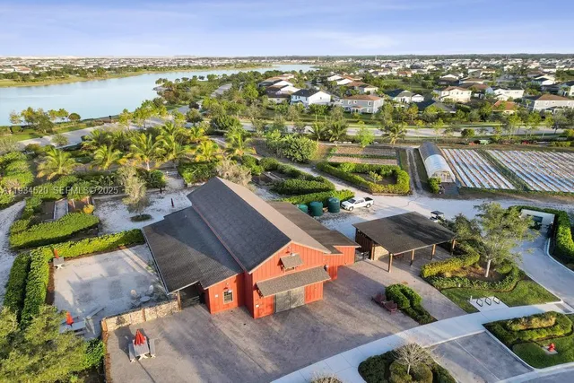 a view of a swimming pool with a yard and a large tree