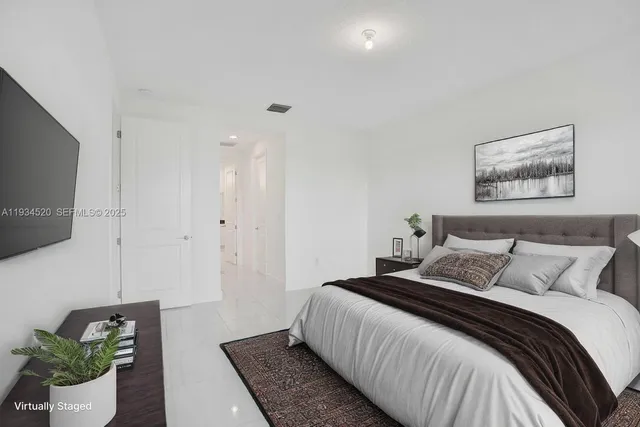 a large white kitchen with a sink and cabinets