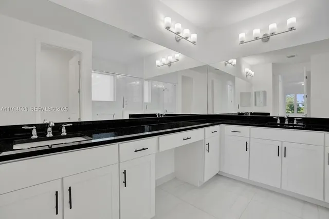 a bedroom with a large bed and a flat screen tv