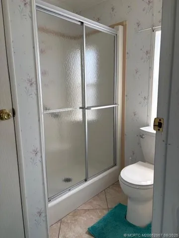 a bathroom with a glass shower door