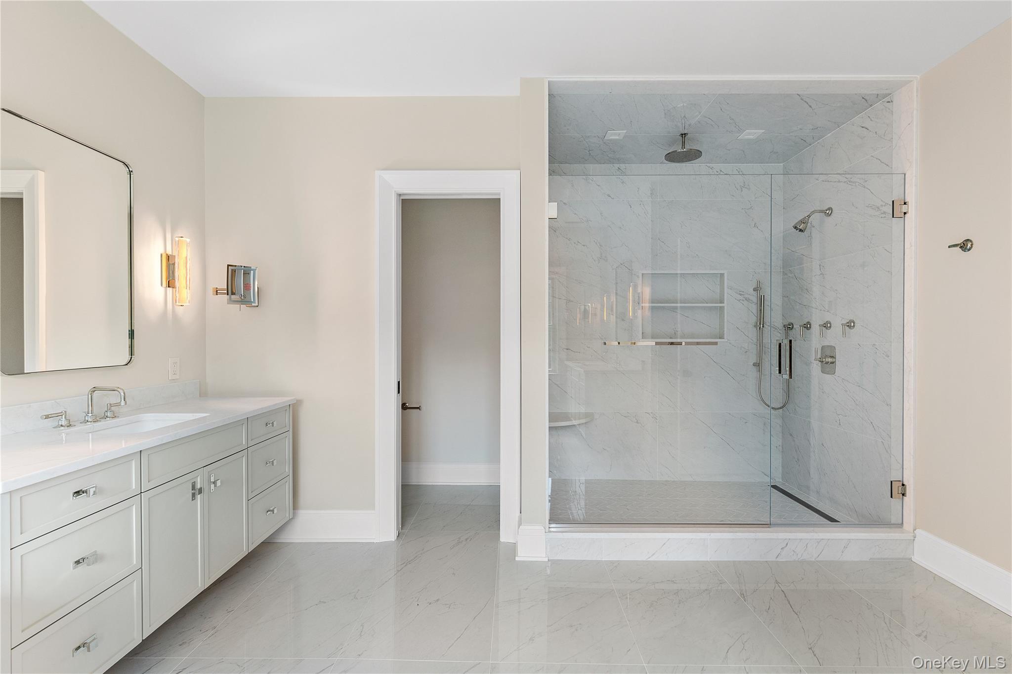 42 Mamaroneck Road Scarsdale, NY 10583 - Photo 31 of 47 The spa-inspired primary bath is thoughtfully designed with dual vanities, a freestanding soaking tub, an oversized glass-enclosed shower, and a private water closet.