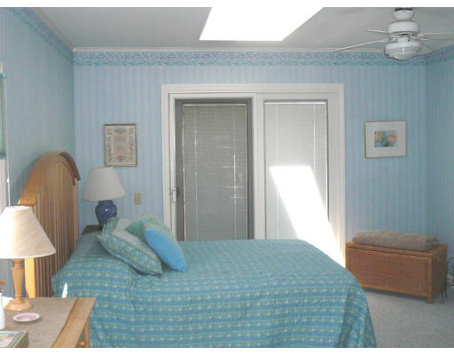 125 Hackensack Road Boston, MA 02467 - Photo 7 of 7 a bedroom with a bed and a lamp