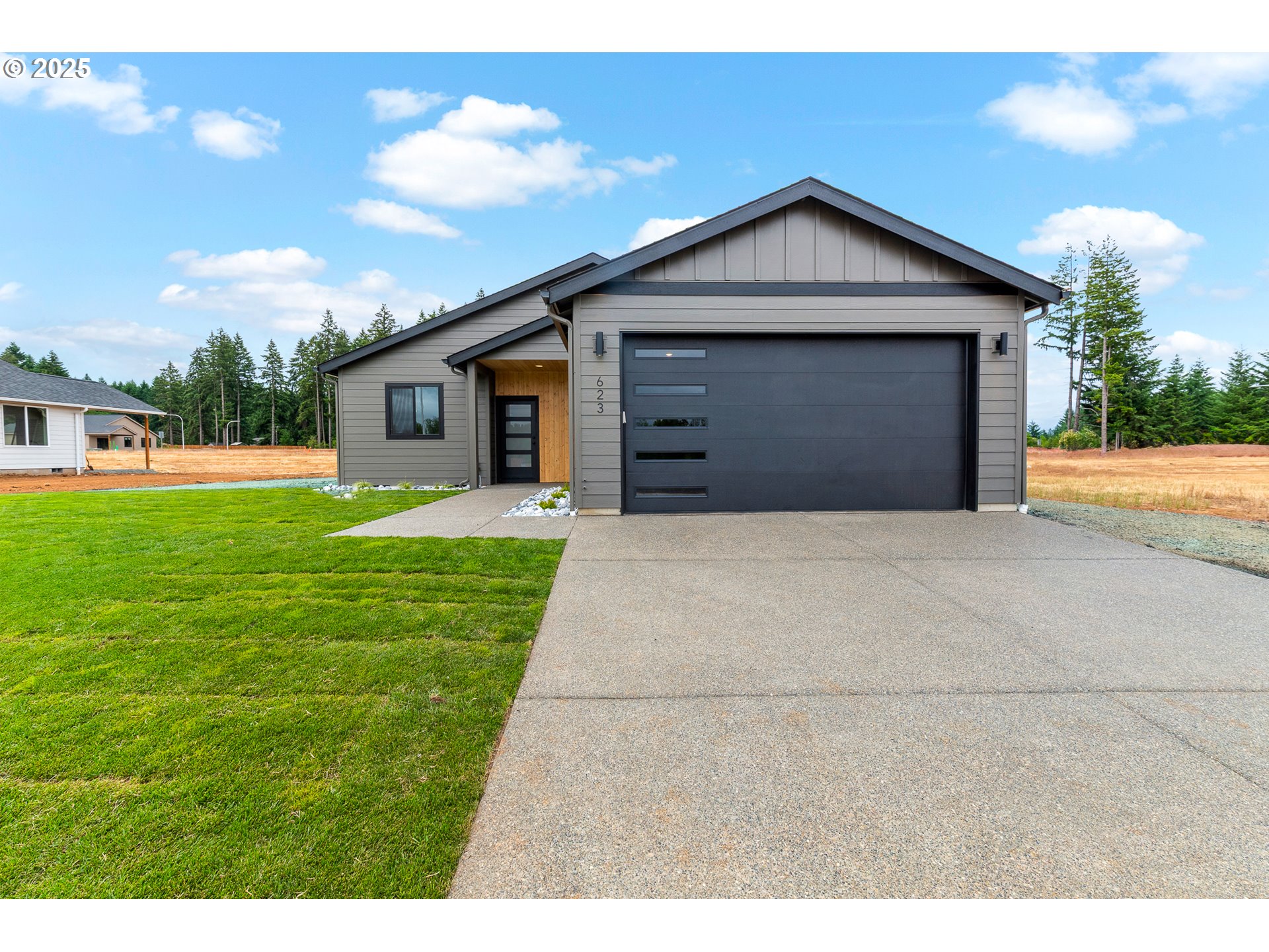 a view of a house with a yard and garage