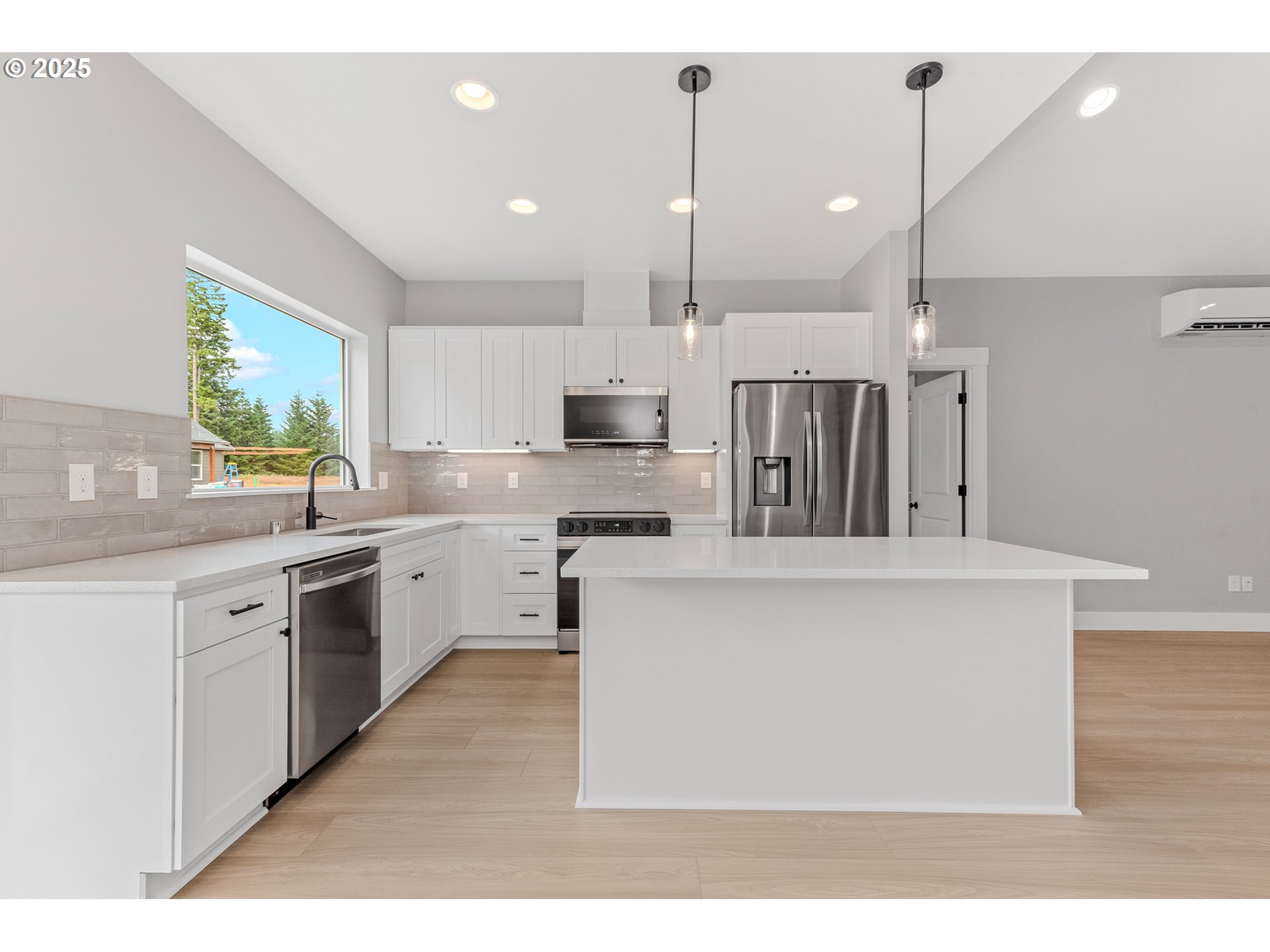 623 Vertex Street Winlock, WA 98596 - Photo 12 of 38 a kitchen with kitchen island a sink stainless steel appliances and cabinets