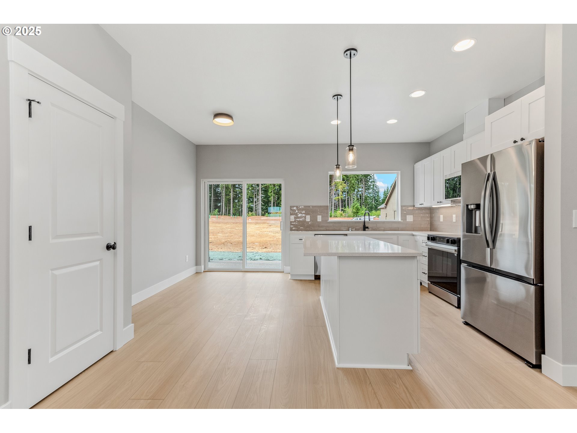 623 Vertex Street Winlock, WA 98596 - Photo 8 of 38 a kitchen with a refrigerator and a wooden floor