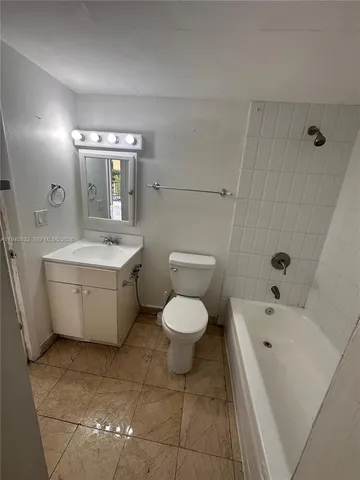 a white toilet sitting next to a bathroom sink
