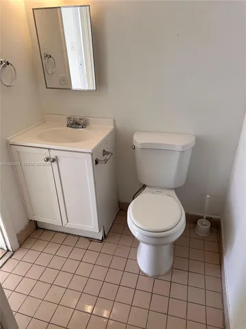 a white toilet sitting next to a white sink
