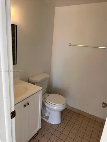 a white toilet sitting next to a bathroom sink