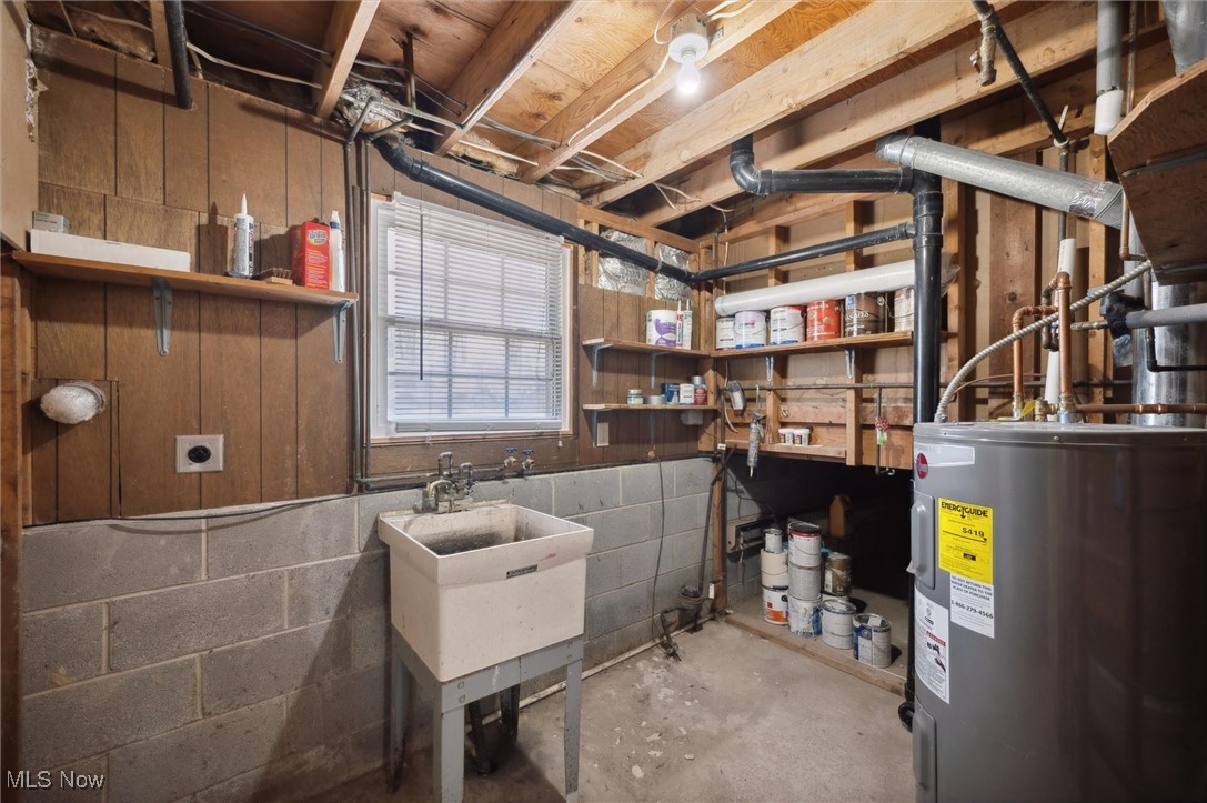 5476 Lear Nagle Road North Ridgeville, OH 44039 - Photo 30 of 38 Below grade area featuring concrete block wall and electric water heater