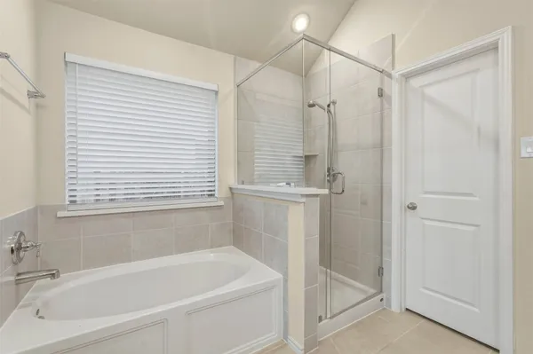 a white bath tub sitting next to a shower