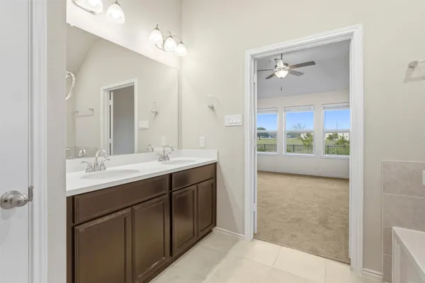 a bathroom with a double vanity sink and a mirror