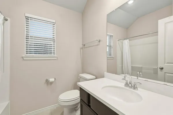 a bathroom with a sink toilet and a mirror