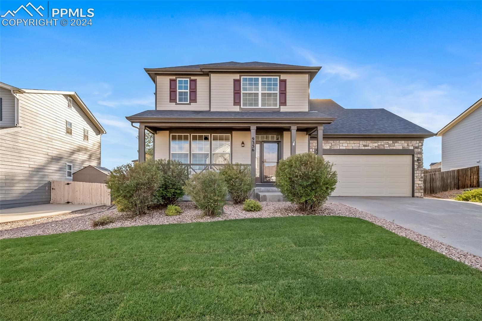 9356 Bethpage Road Peyton, CO 80831 - Photo 1 of 40 Front of property featuring a front lawn, a porch, and a garage