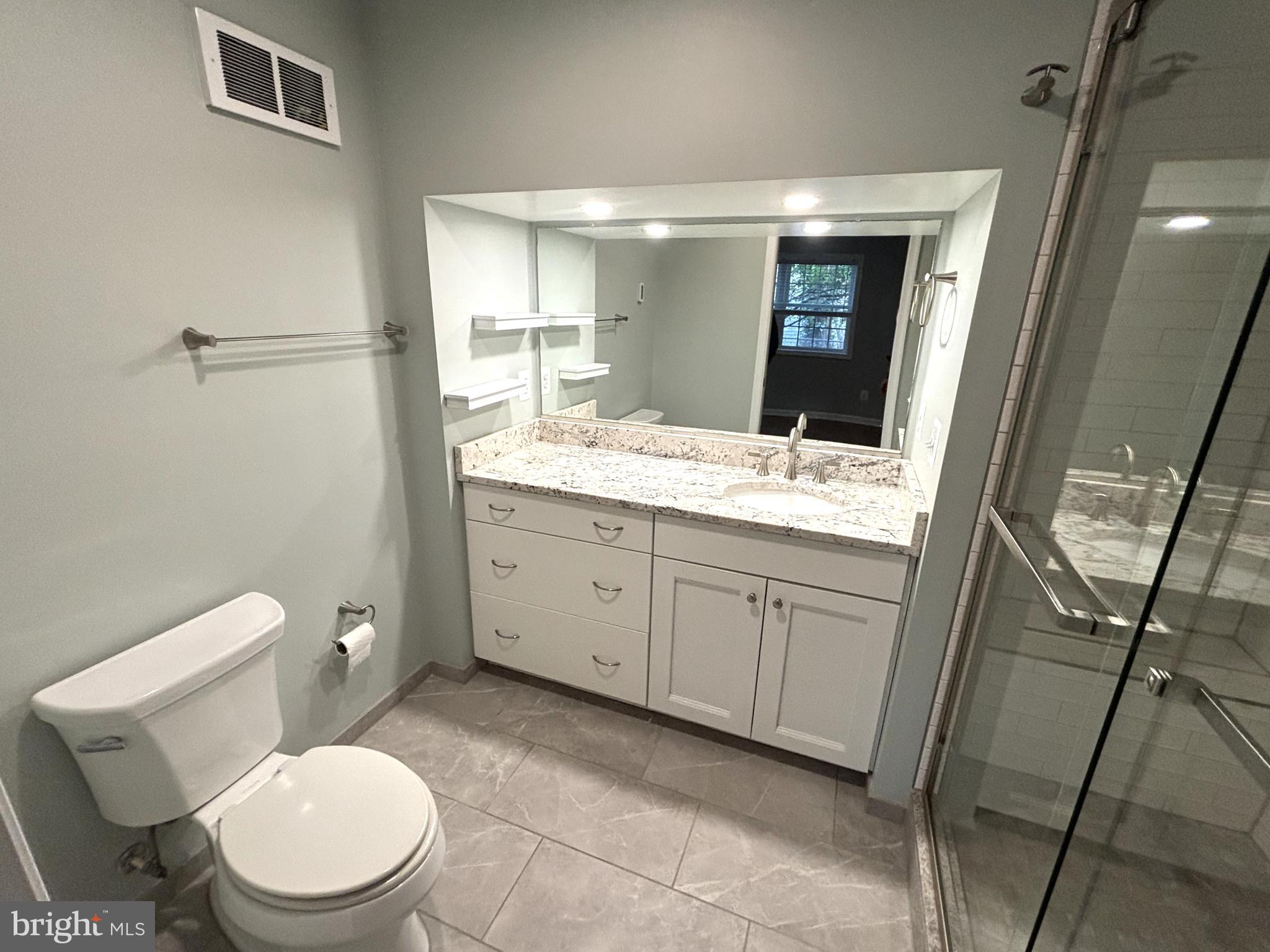3512 Gunston Road Alexandria, VA 22302 - Photo 13 of 29 a bathroom with a granite countertop toilet sink and mirror
