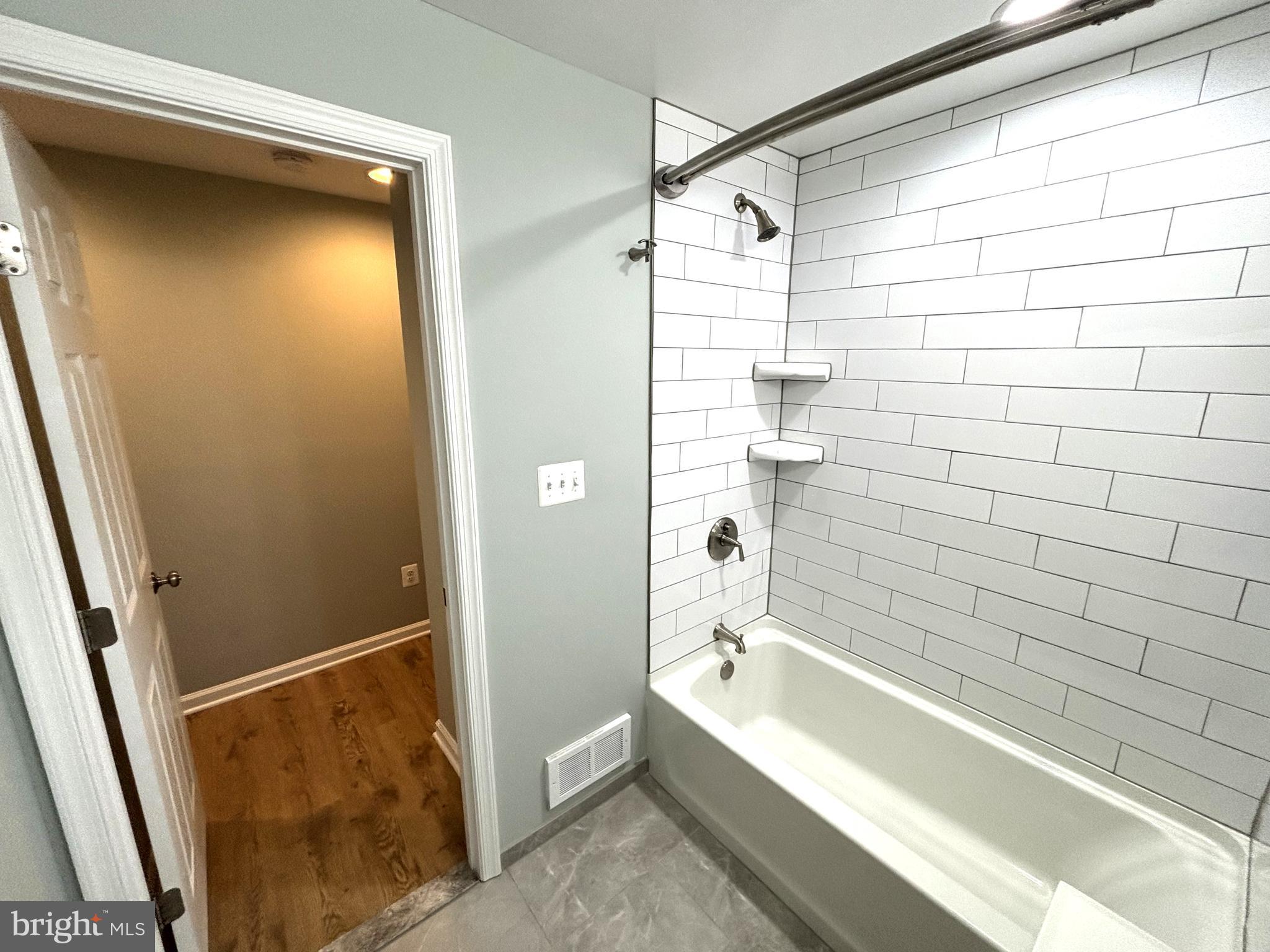 3512 Gunston Road Alexandria, VA 22302 - Photo 16 of 29 a bathroom with a shower and a bathtub