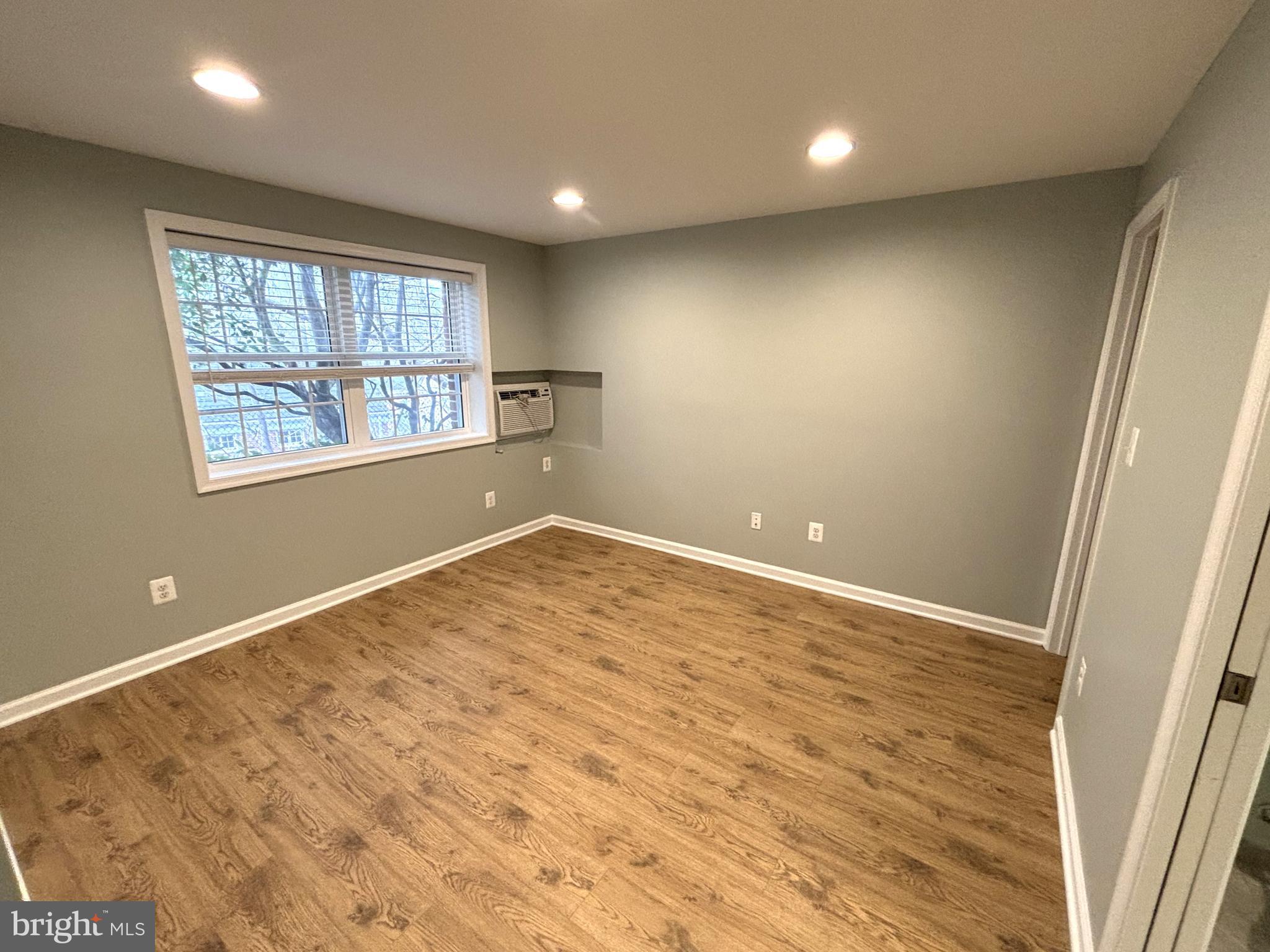 3512 Gunston Road Alexandria, VA 22302 - Photo 9 of 29 an empty room with wooden floor and windows