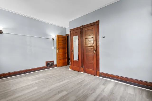 a view of an empty room with wooden floor
