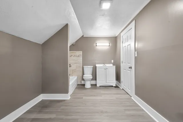 a view of a room with wooden floor