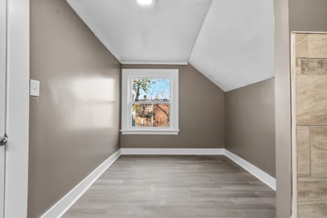 an empty room with windows and closet