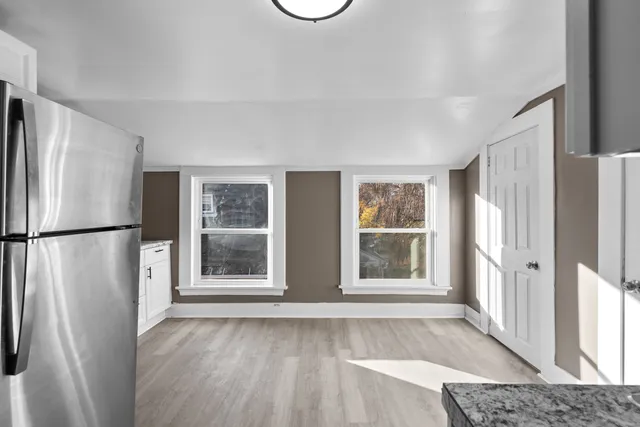 a kitchen with a refrigerator and a stove