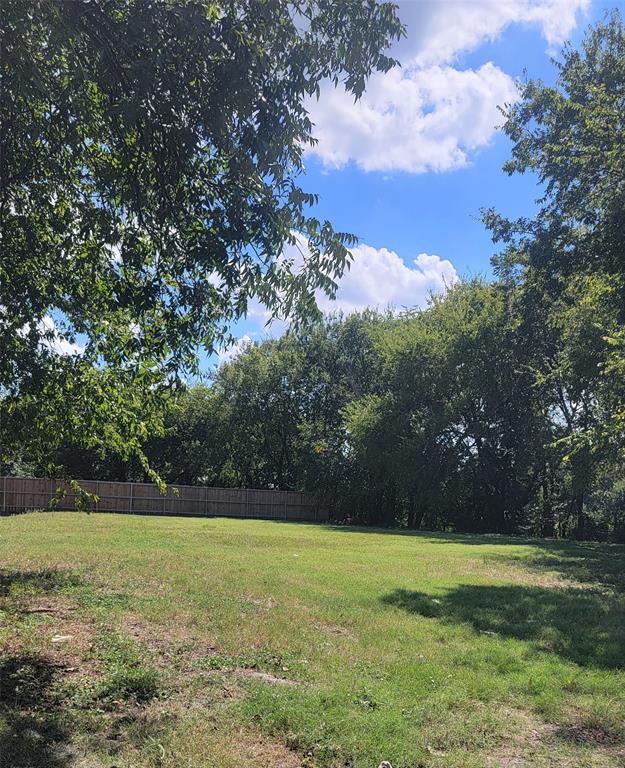 5518 Nomas Street Dallas, TX 75212 - Photo 1 of 1 a view of yard with green space and trees in the background