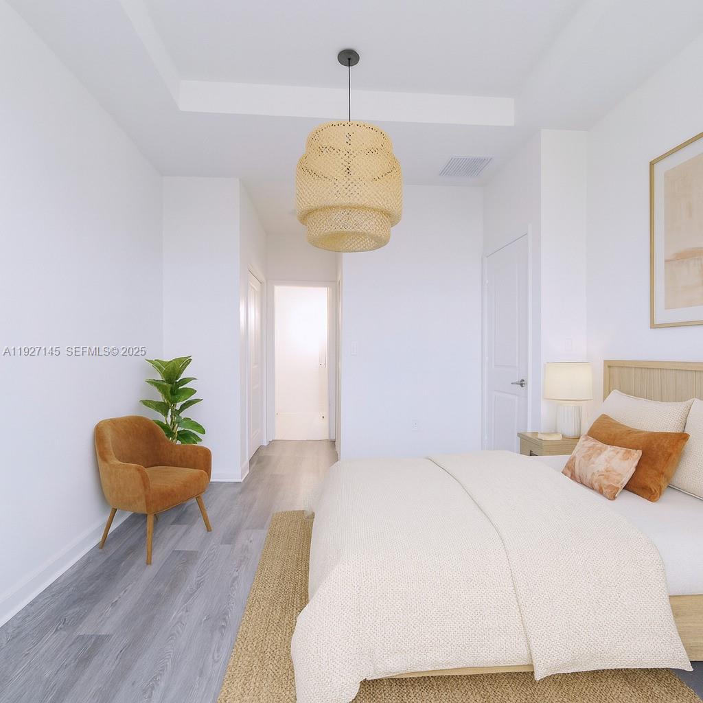 12661 Northwest 23rd Place Miami, FL 33167 - Photo 20 of 34 a bedroom with a bed and a chandelier