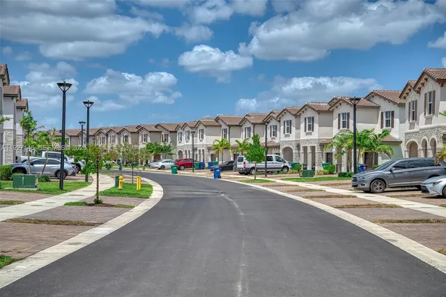 a city street lined with buildings and trees