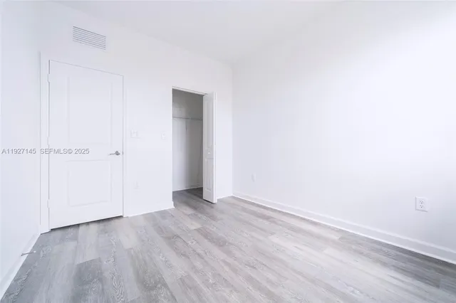 an empty room with wooden floor
