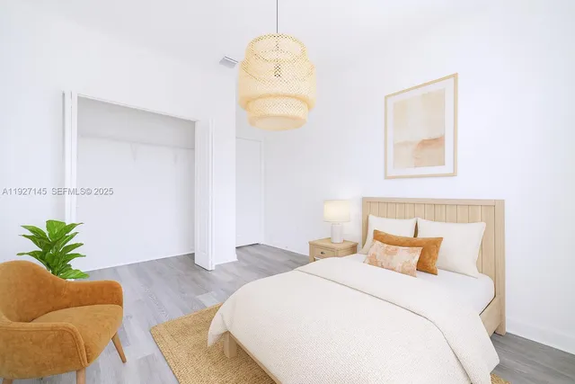 a bedroom with a bed and a couch