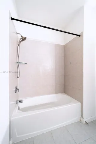 a bathroom with a shower and a bath tub