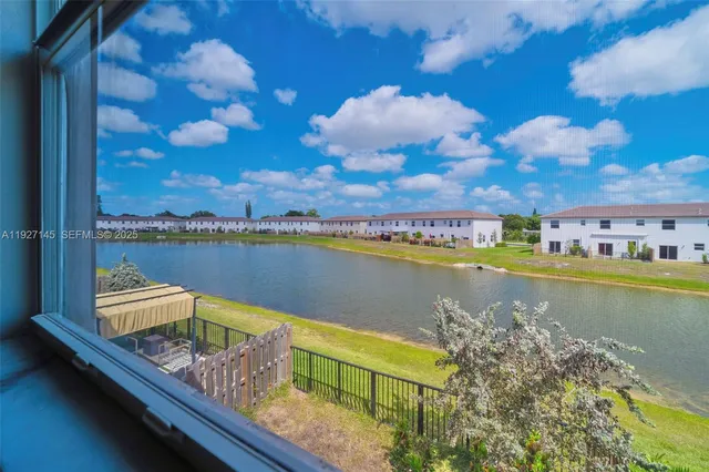 a view of a lake with couches chairs