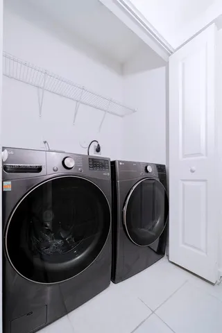 a utility room with sink dryer and washer